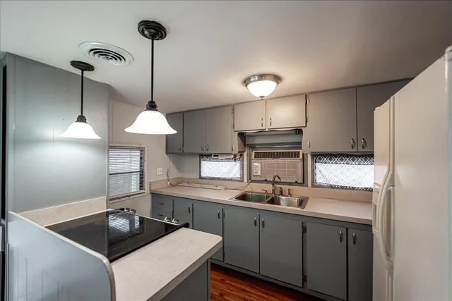 a kitchen with a sink a counter space and cabinets