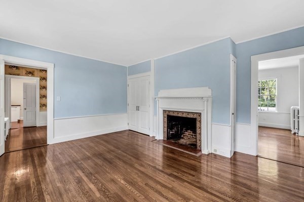 81 Fearing Road Hingham, MA 02043 - Photo 15 of 42 a view of an empty room with wooden floor fireplace and a window