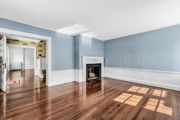 81 Fearing Road Hingham, MA 02043 - Photo 17 of 42 a view of a livingroom with wooden floor and a fireplace