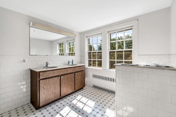 81 Fearing Road Hingham, MA 02043 - Photo 29 of 42 a large white kitchen with granite countertop a sink and a stove