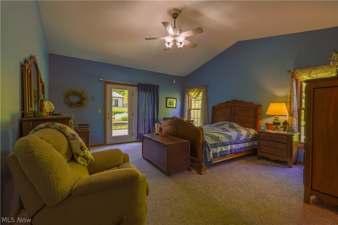 5675 Post Boy Road Southwest Newcomerstown, OH 43832 - Photo 11 of 26 Carpeted bedroom featuring vaulted ceiling, ceiling fan, and access to exterior