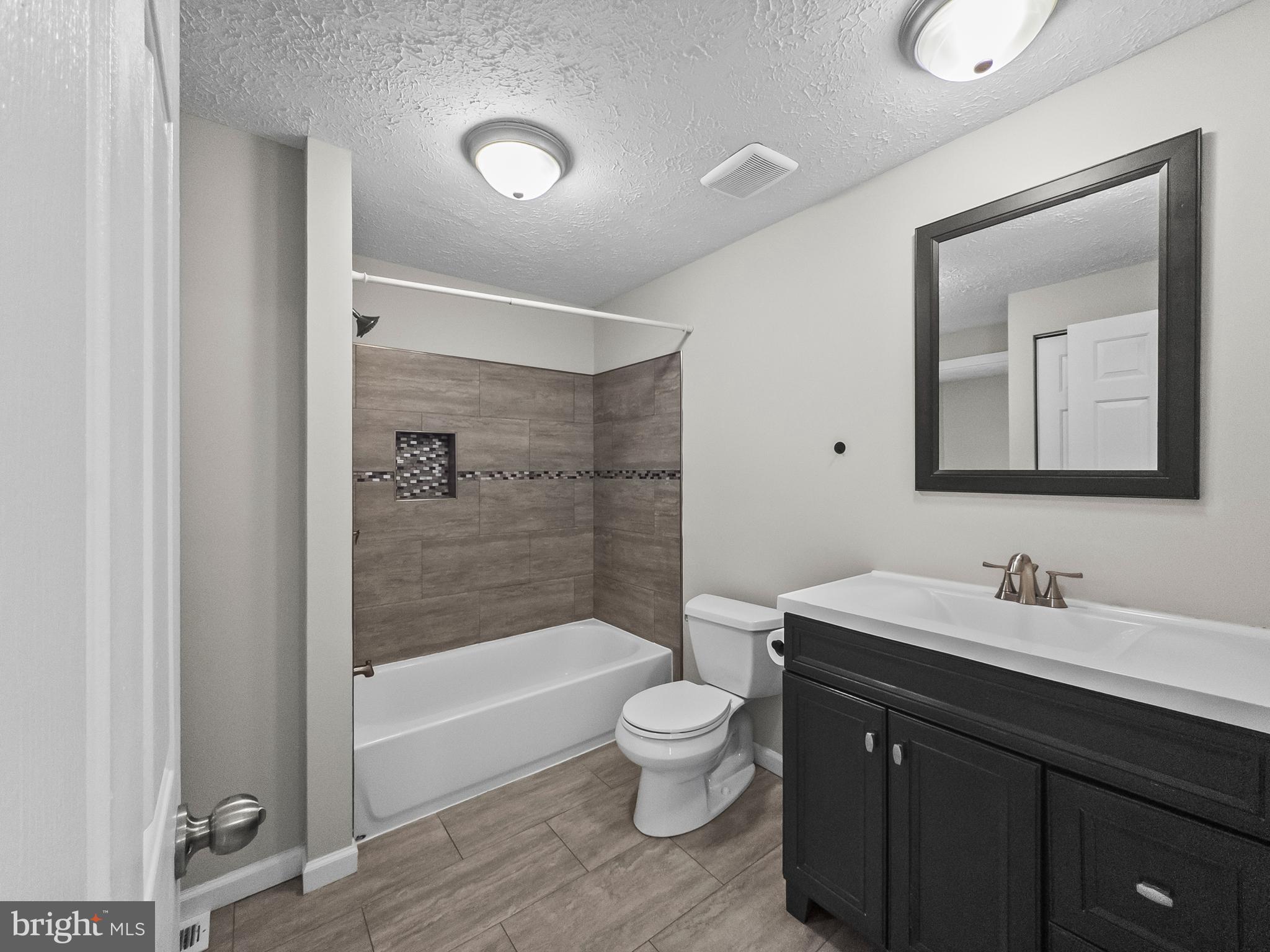 10110 Shelldrake Circle Damascus, MD 20872 - Photo 18 of 35 a bathroom with a toilet a sink and a bathtub