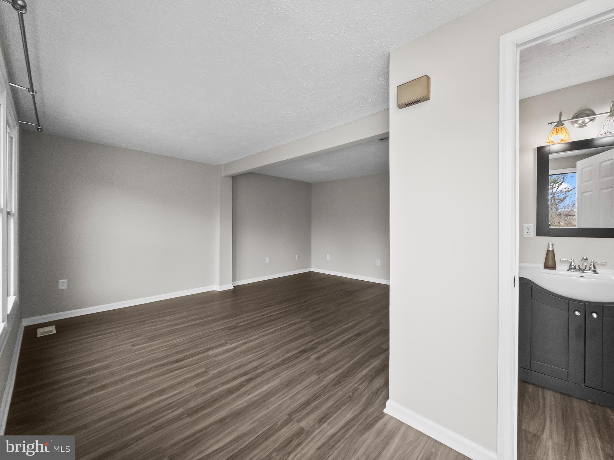 10110 Shelldrake Circle Damascus, MD 20872 - Photo 2 of 35 a view of wooden floor and windows in a room