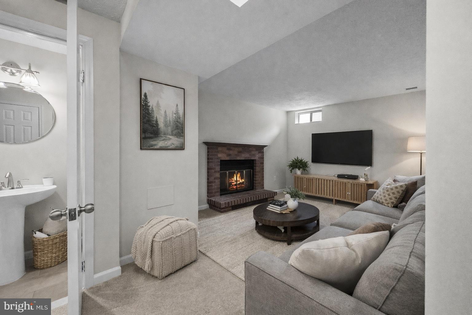 10110 Shelldrake Circle Damascus, MD 20872 - Photo 24 of 35 a living room with furniture a flat screen tv and a fireplace
