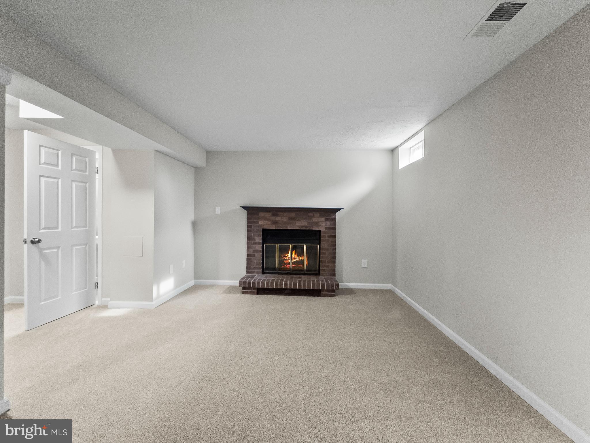 10110 Shelldrake Circle Damascus, MD 20872 - Photo 27 of 35 a view of an empty room with a fireplace and a window