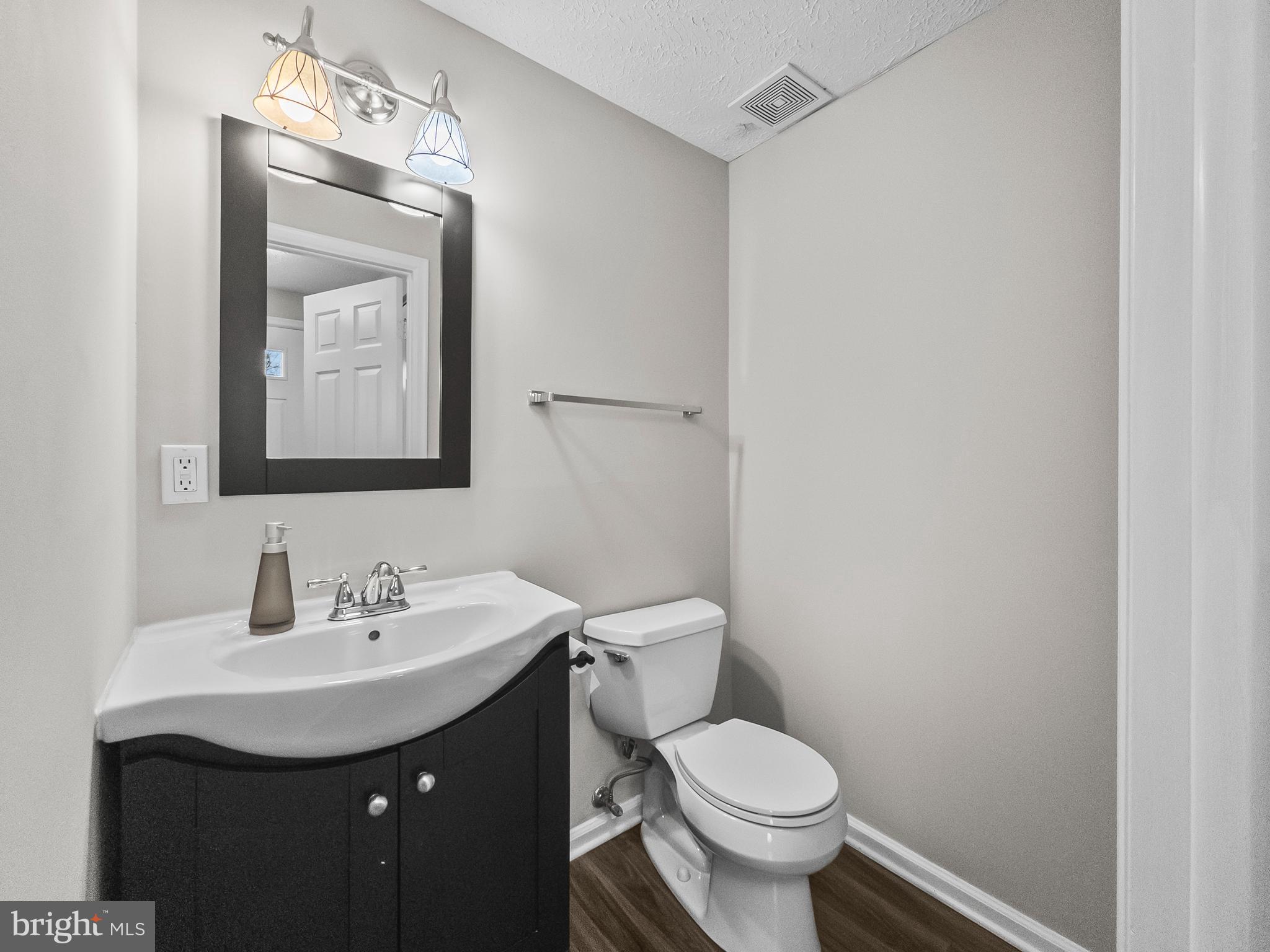 10110 Shelldrake Circle Damascus, MD 20872 - Photo 3 of 35 a bathroom with a toilet sink and mirror