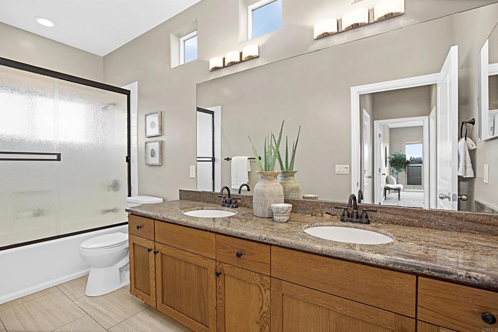 363 Maria Avenue Spring Valley, CA 91977 - Photo 17 of 19 a bathroom with a granite countertop sink toilet and mirror