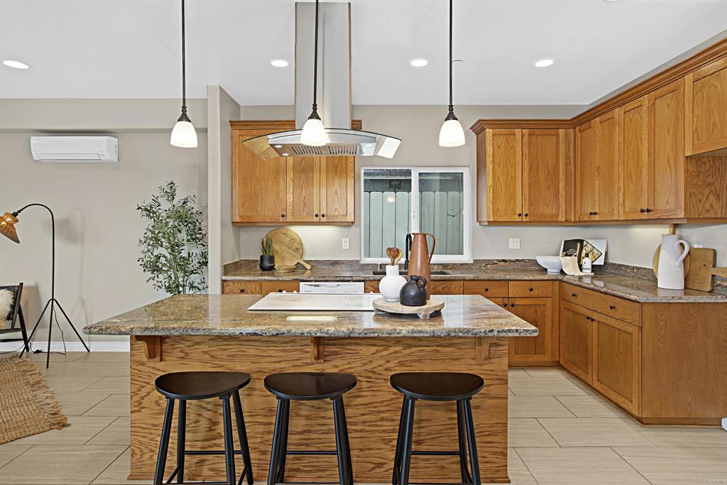 363 Maria Avenue Spring Valley, CA 91977 - Photo 6 of 19 a kitchen with granite countertop a sink a stove and cabinets