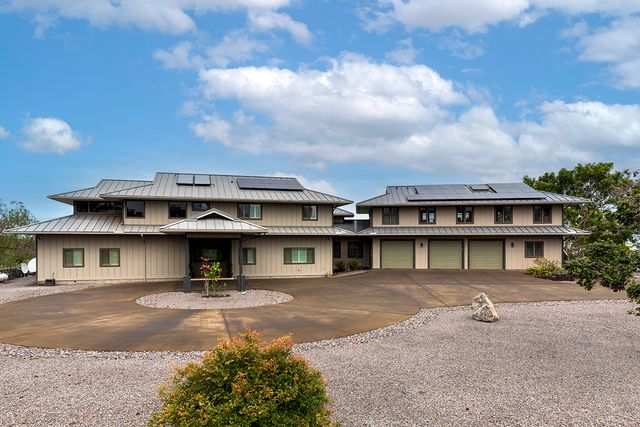 a front view of a residential apartment building with a yard