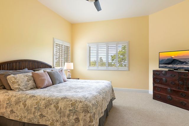 a bedroom with a bed and a television