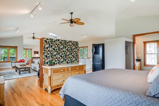 a bedroom with a bed and a chandelier