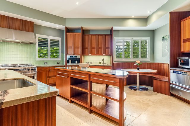 a kitchen with a stove a sink and a refrigerator