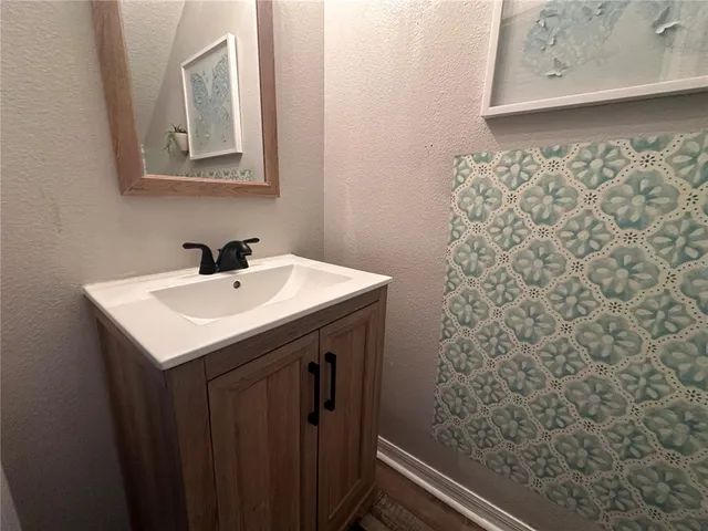 a bathroom with a sink and a mirror