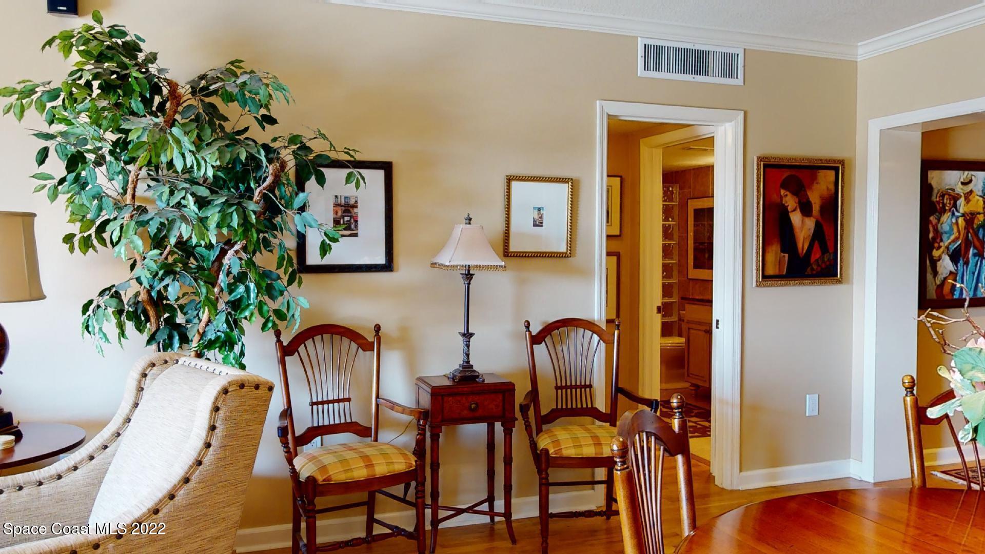 2220 Front Street, Unit 303 Melbourne, FL 32901 - Photo 12 of 29 a dining room with furniture and wooden floor