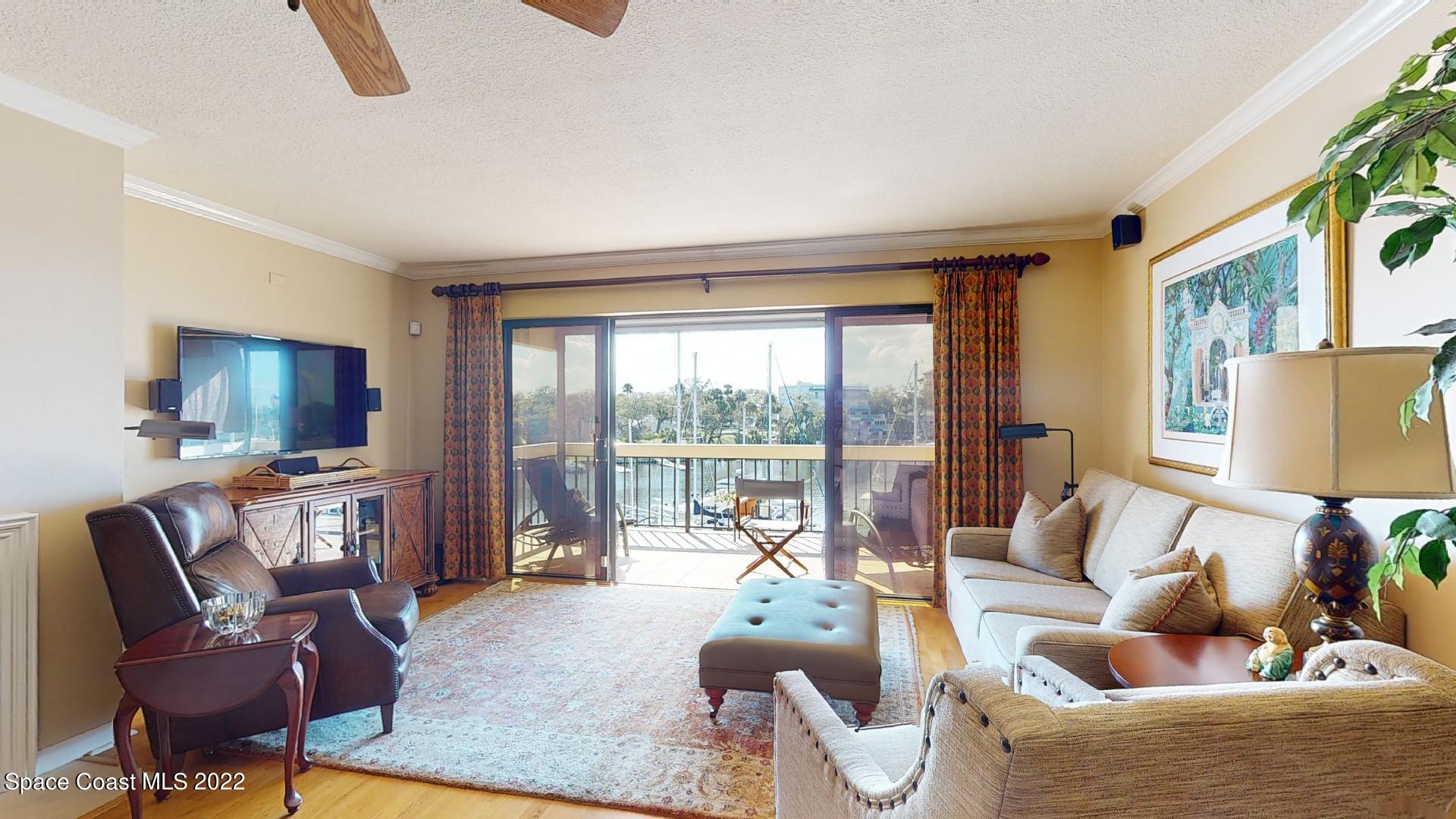 2220 Front Street, Unit 303 Melbourne, FL 32901 - Photo 13 of 29 a living room with furniture and a flat screen tv