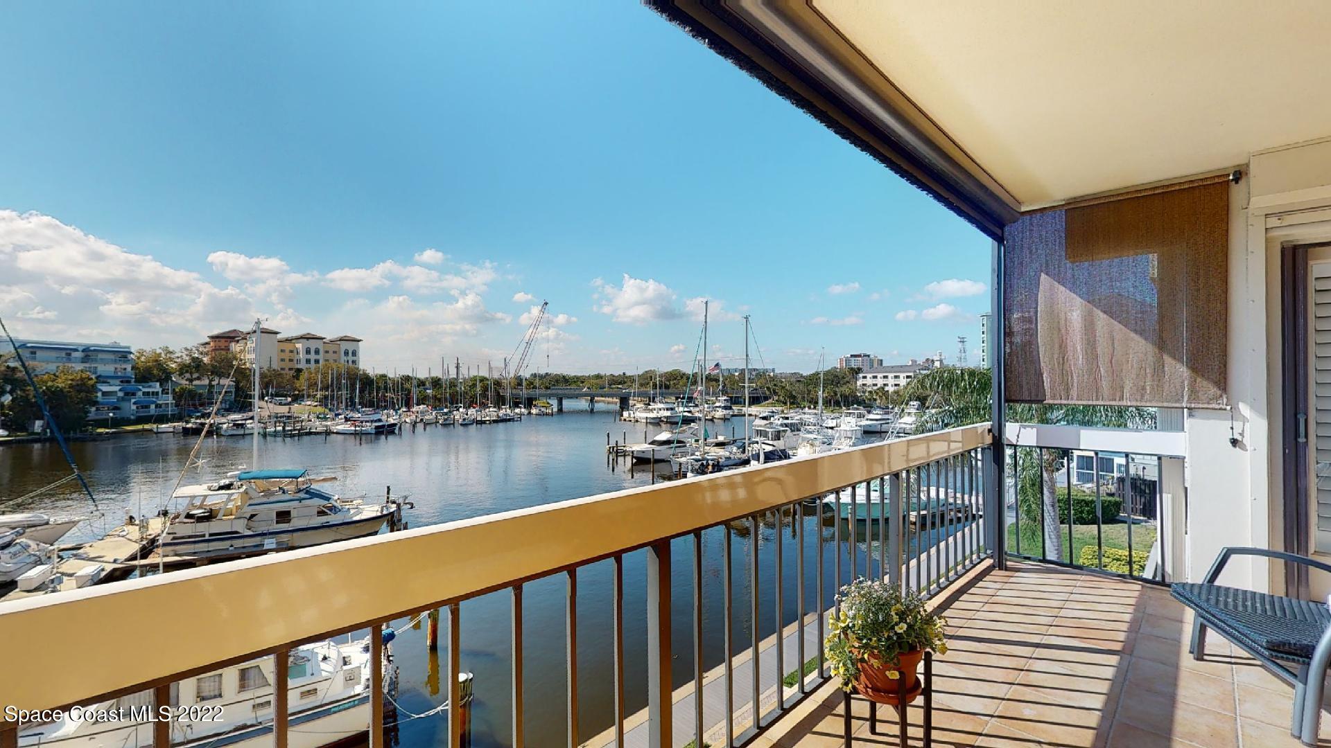 2220 Front Street, Unit 303 Melbourne, FL 32901 - Photo 17 of 29 a balcony with wooden floor and lake view