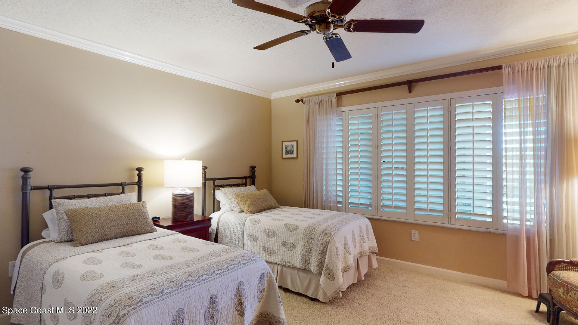 2220 Front Street, Unit 303 Melbourne, FL 32901 - Photo 22 of 29 a bedroom with two beds and a window