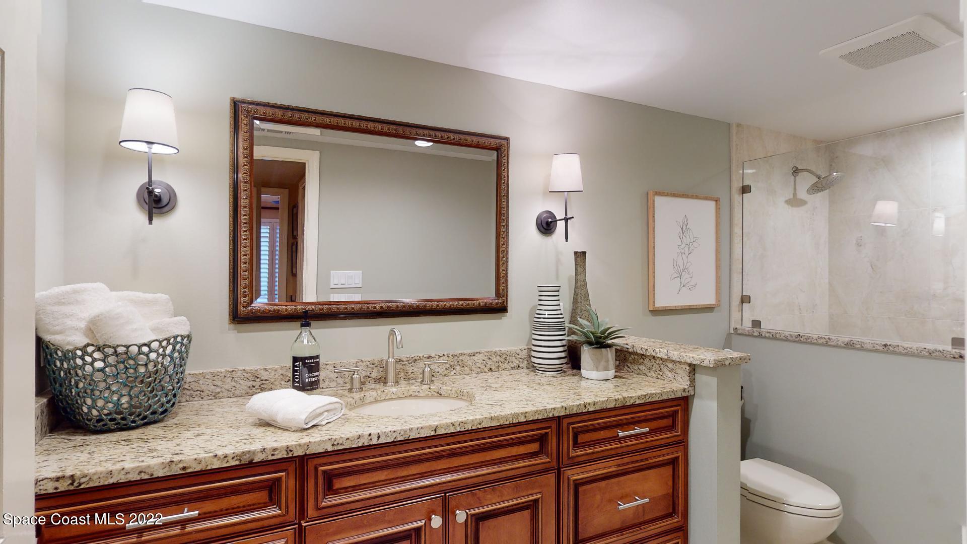 2220 Front Street, Unit 303 Melbourne, FL 32901 - Photo 25 of 29 a bathroom with a granite countertop sink and a mirror
