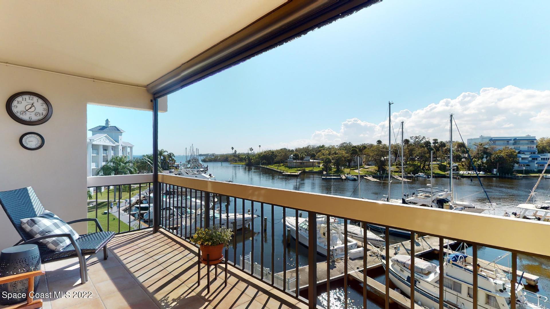 2220 Front Street, Unit 303 Melbourne, FL 32901 - Photo 27 of 29 a view of a balcony with wooden chairs and a table