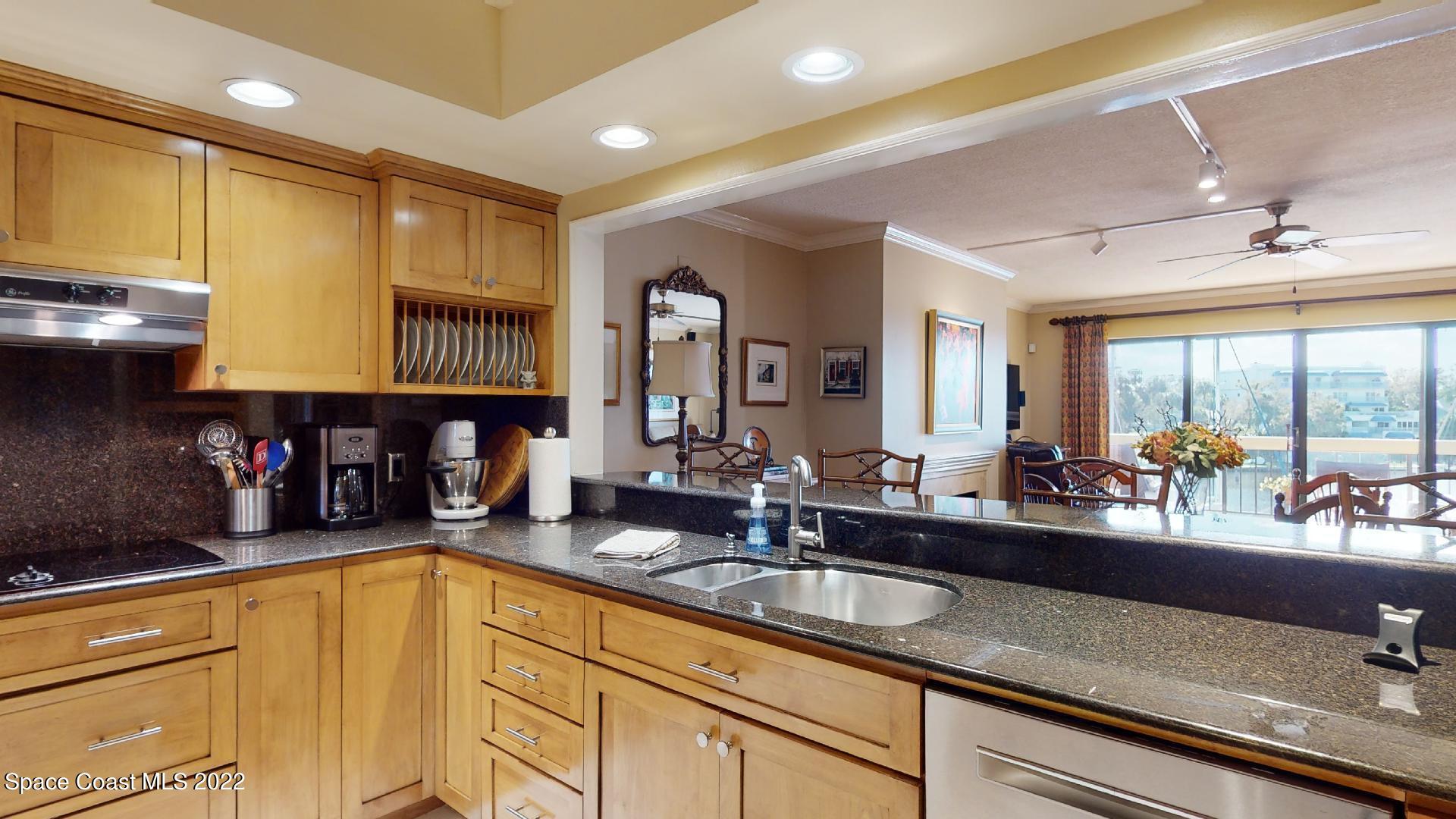 2220 Front Street, Unit 303 Melbourne, FL 32901 - Photo 7 of 29 a kitchen with sink a window and living room view