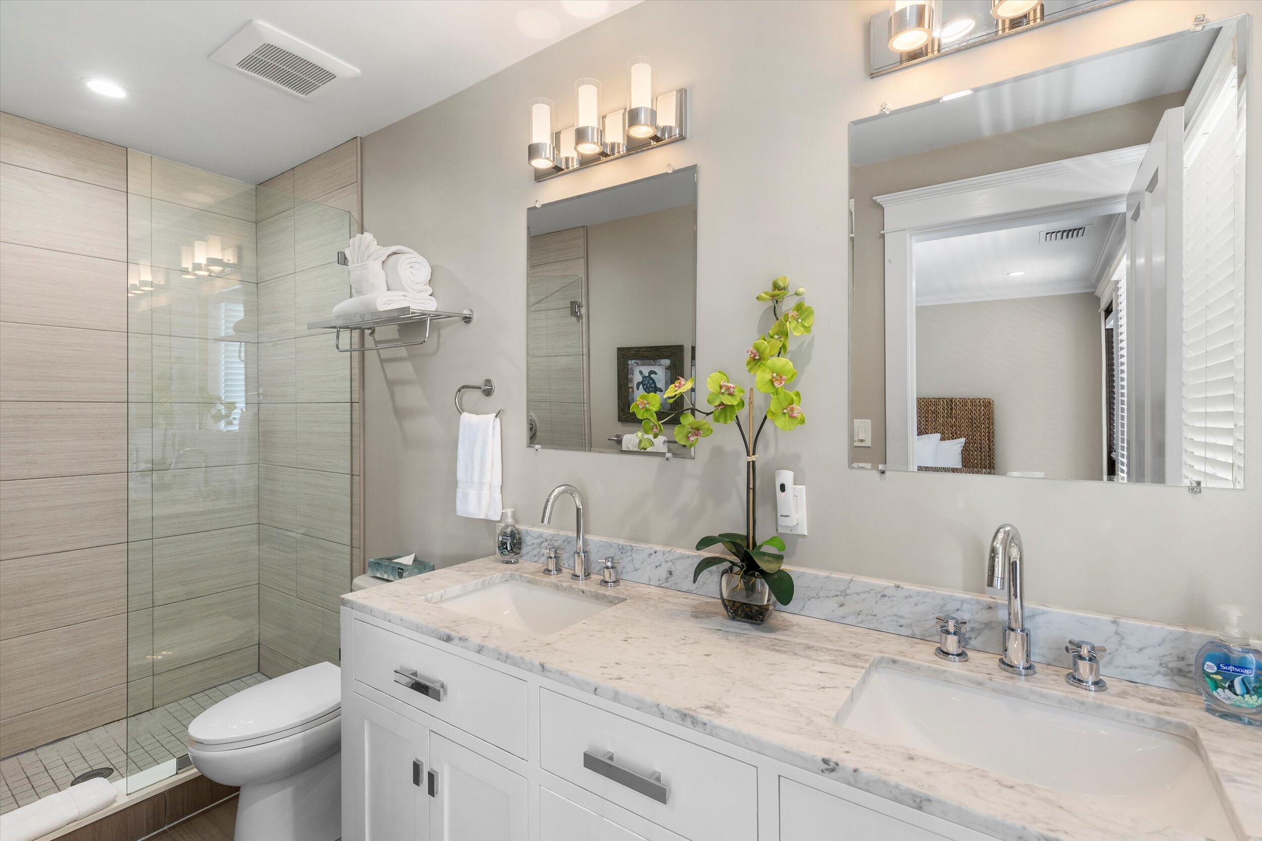 421-423 Simonton Street Key West, FL 33040 - Photo 12 of 37 a bathroom with a granite countertop sink a toilet and shower
