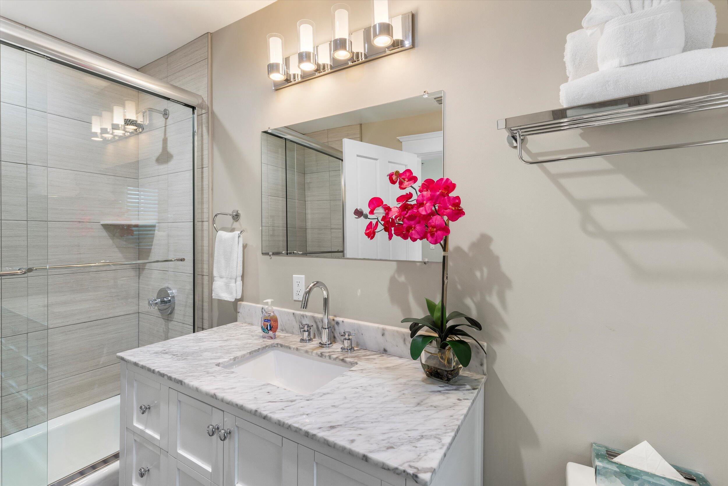 421-423 Simonton Street Key West, FL 33040 - Photo 15 of 37 a bathroom with a granite countertop sink a mirror and shower