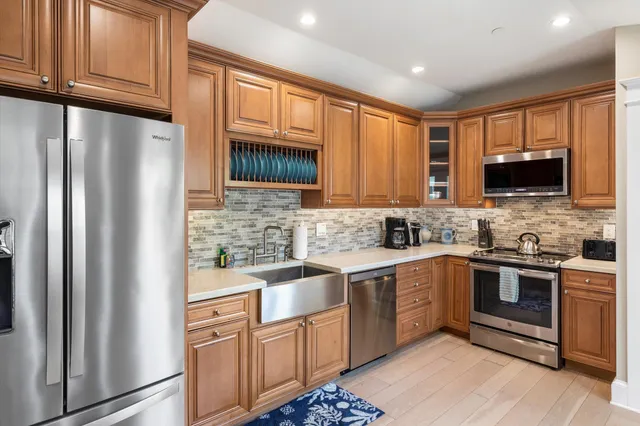 a kitchen with stainless steel appliances granite countertop a refrigerator stove microwave and sink