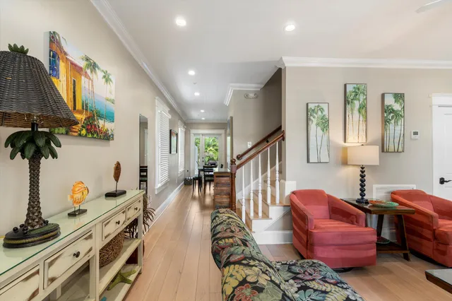 a living room with furniture and wooden floor