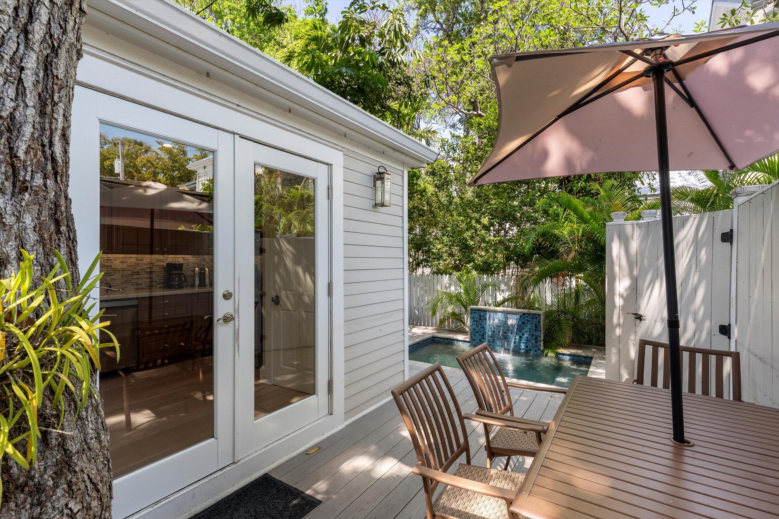 421-423 Simonton Street Key West, FL 33040 - Photo 22 of 37 a view of patio with a table and chairs