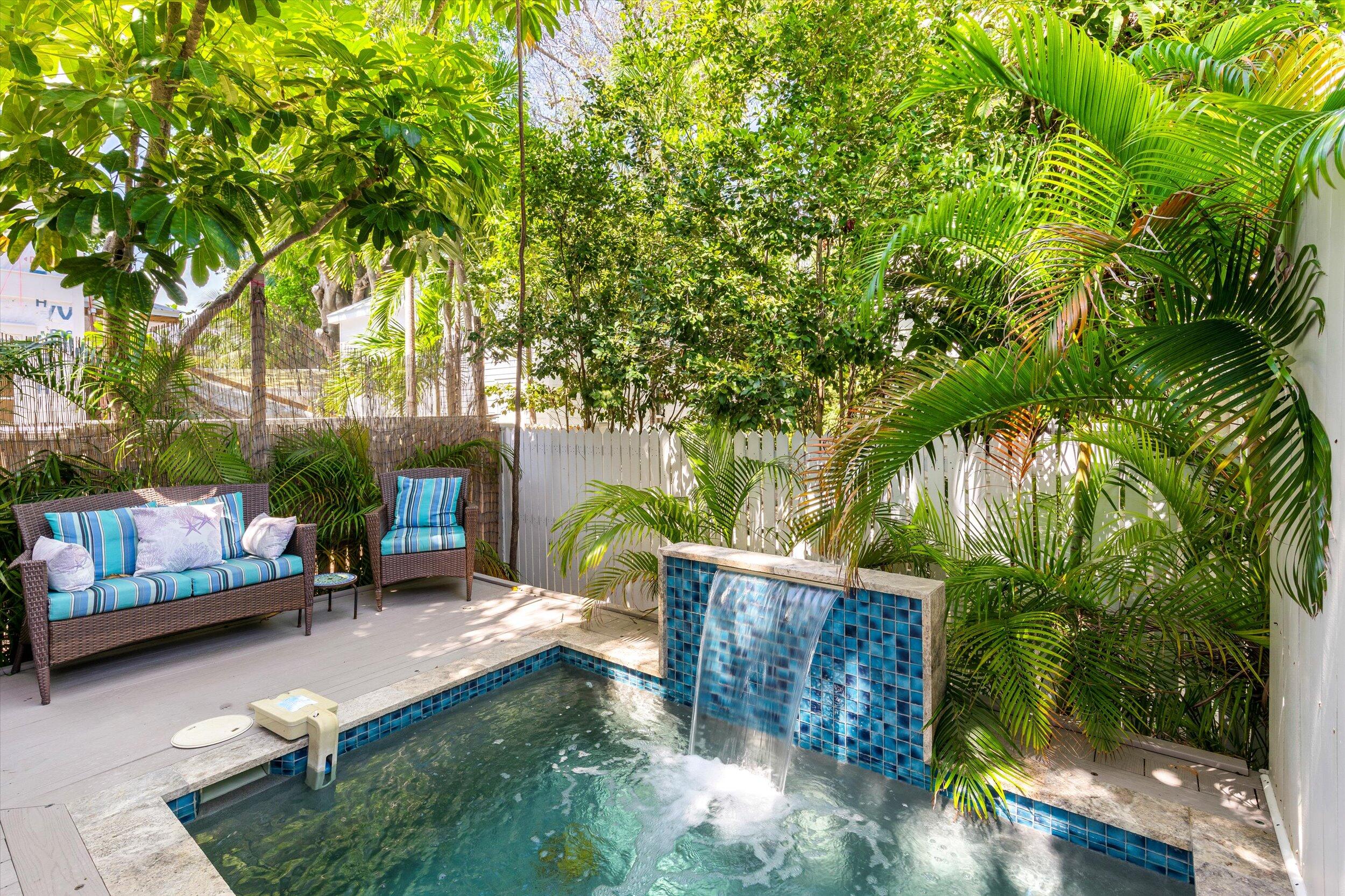 421-423 Simonton Street Key West, FL 33040 - Photo 23 of 37 a view of a backyard with a patio