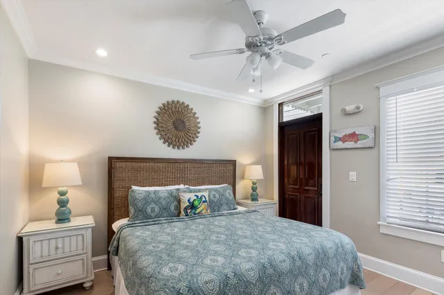 a bedroom with a bed and a lamp on dresser