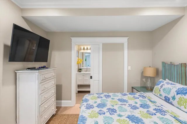 a bedroom with a bed and flat screen tv