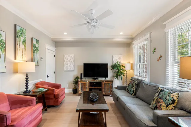 a living room with furniture and a flat screen tv with wooden floor