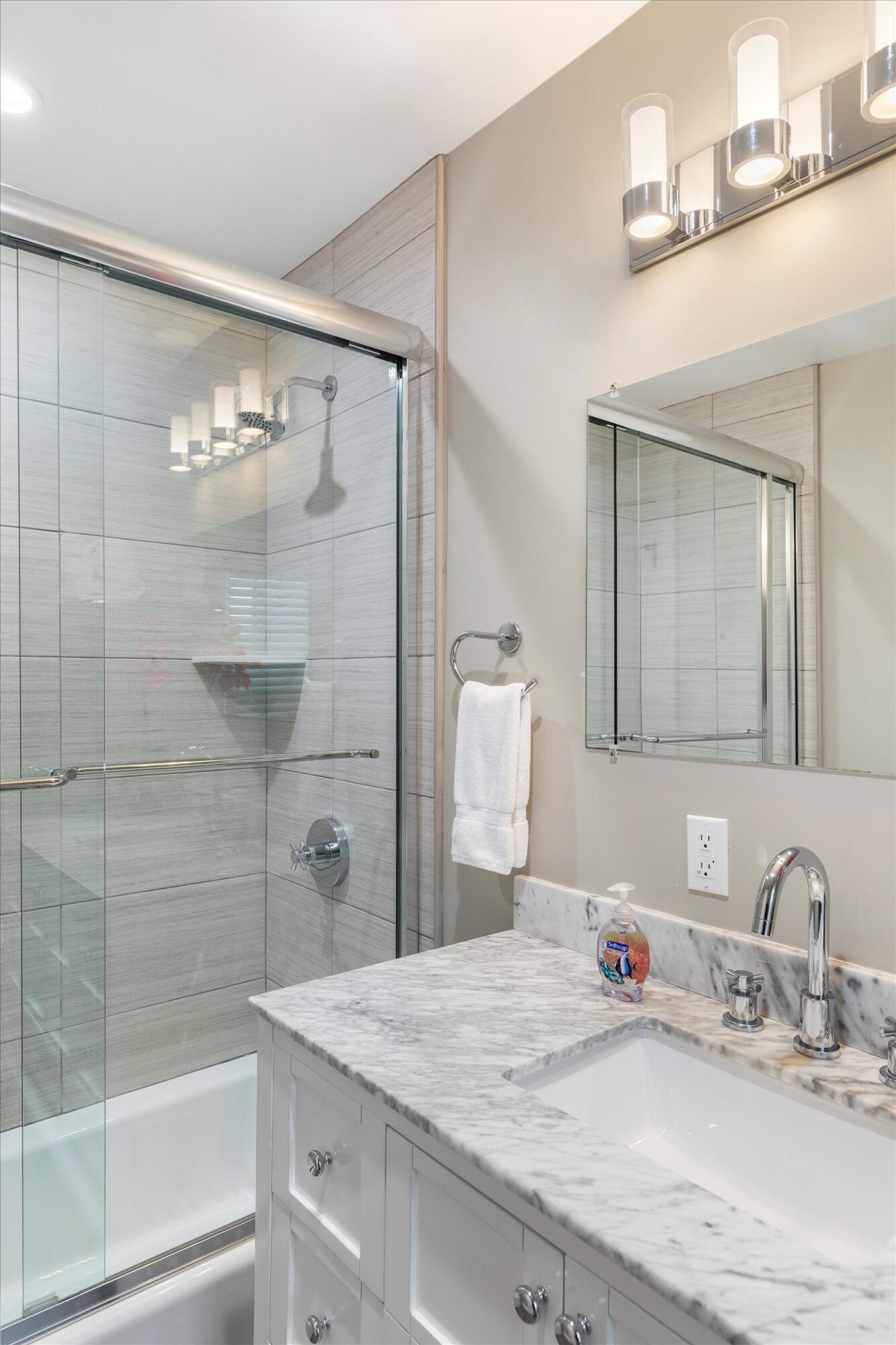 421-423 Simonton Street Key West, FL 33040 - Photo 34 of 37 a bathroom with a granite countertop sink a mirror and shower