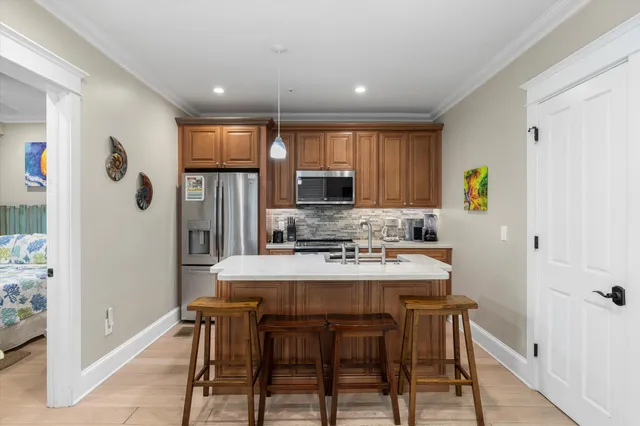 a kitchen with stainless steel appliances granite countertop a refrigerator and a stove top oven