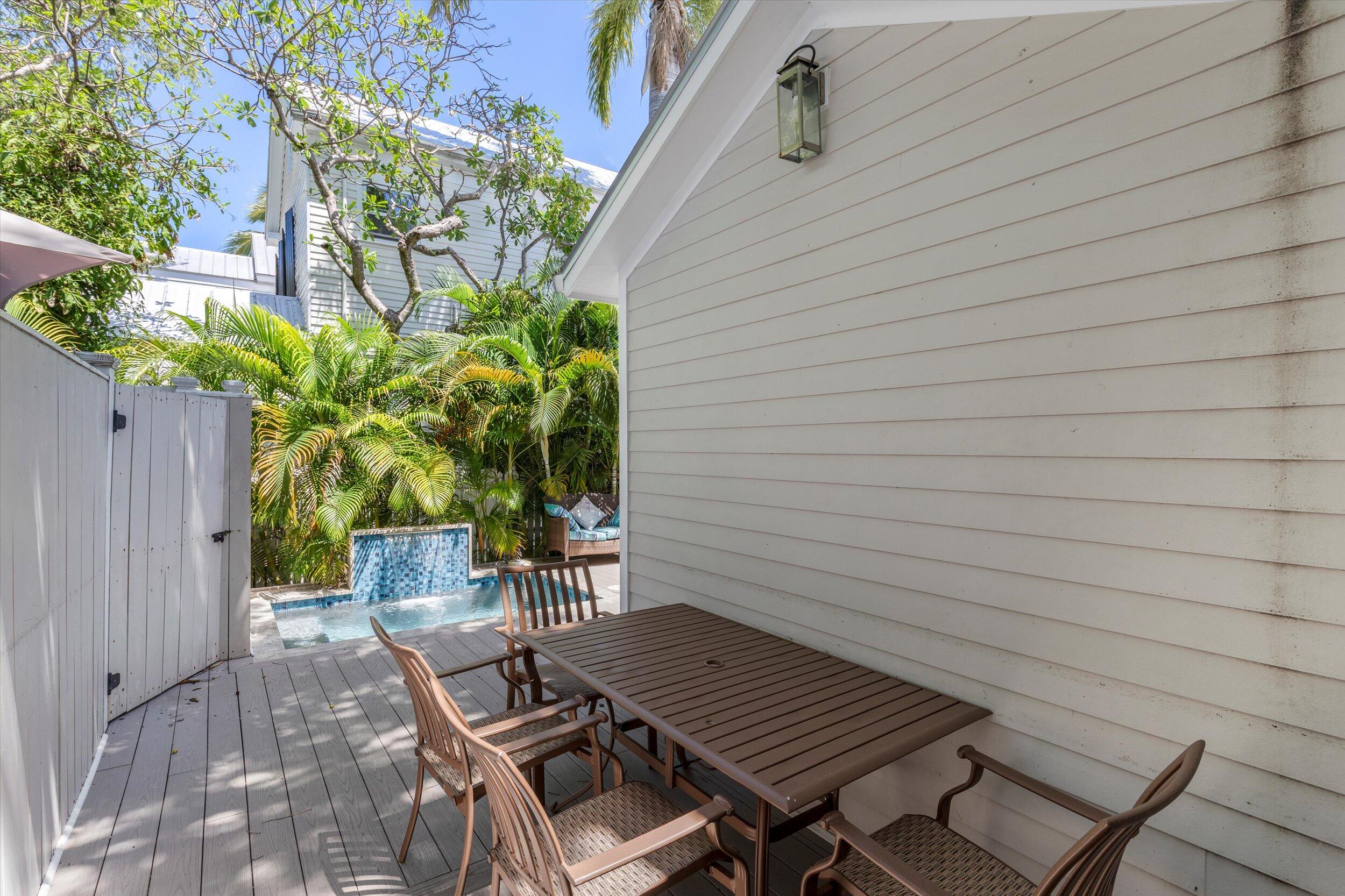 421-423 Simonton Street Key West, FL 33040 - Photo 9 of 37 a view of a backyard with a table and chairs