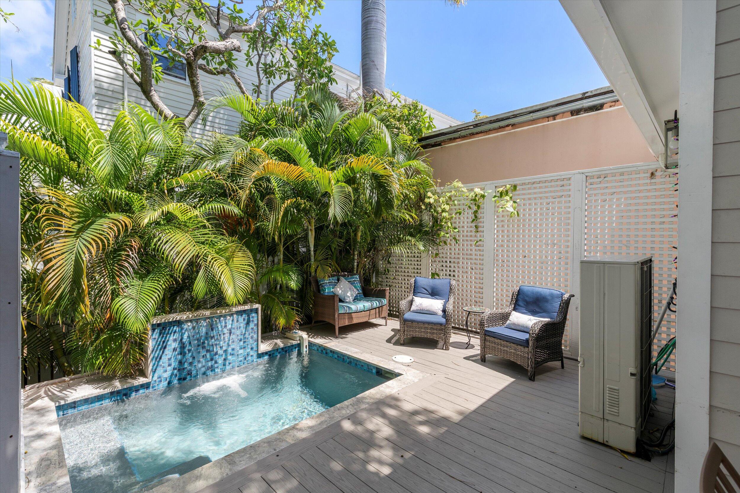 421-423 Simonton Street Key West, FL 33040 - Photo 10 of 37 a view of a patio with couches and potted plants