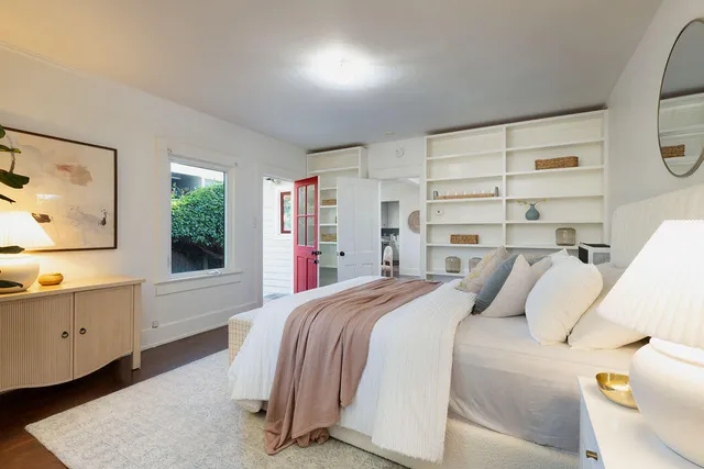 a bedroom with a bed and a window