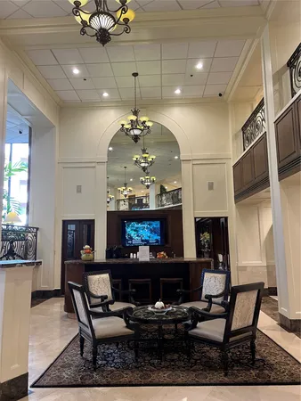 a living room with fireplace furniture and a chandelier