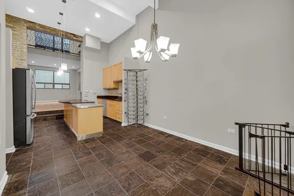 a view of a kitchen with granite countertop natural light and appliances