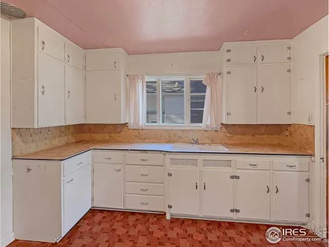 a spacious bathroom with a granite countertop sink and a mirror