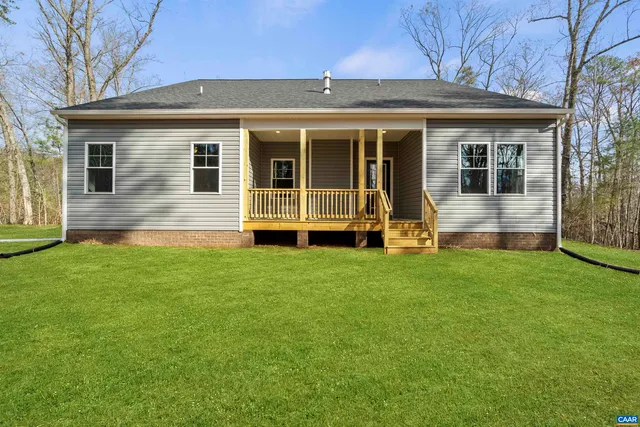 a view of house with backyard