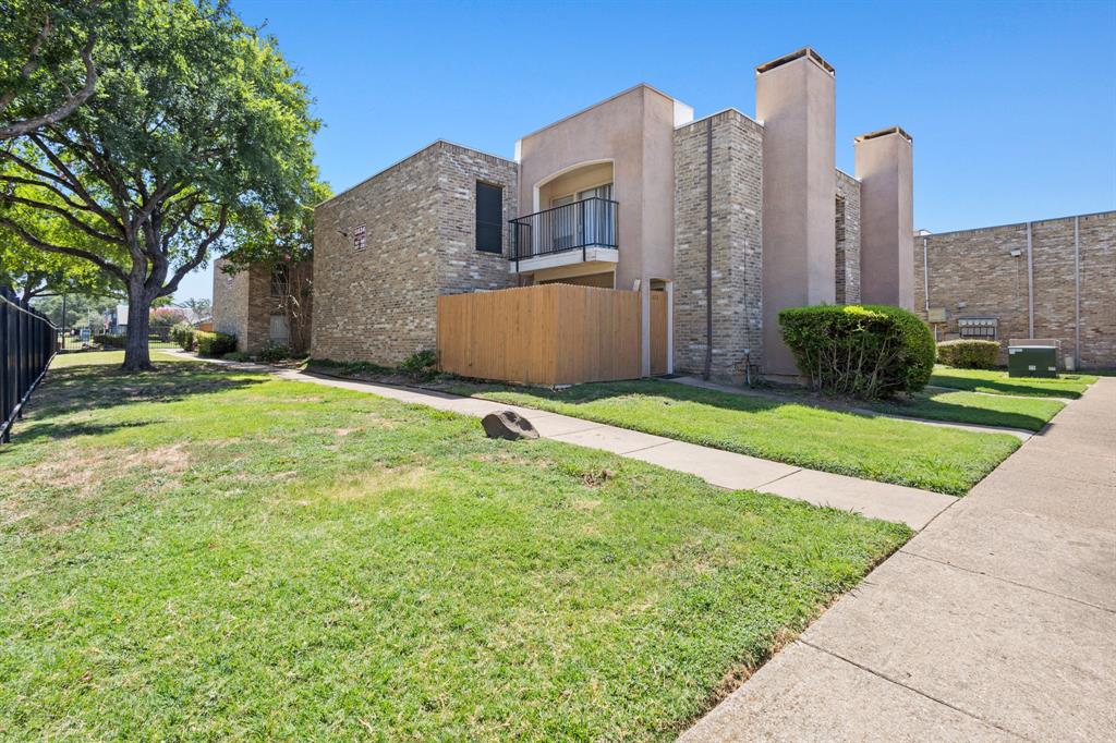 5634 Boca Raton Boulevard, Unit 209 Fort Worth, TX 76112 - Photo 22 of 24 View of side of home with stucco siding and a chimney
