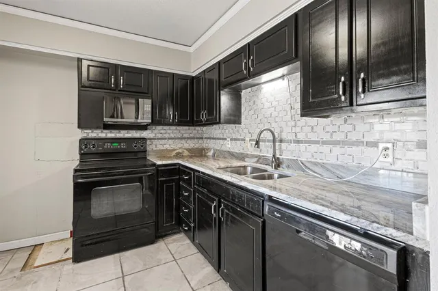 a kitchen with stainless steel appliances granite countertop a sink stove and microwave