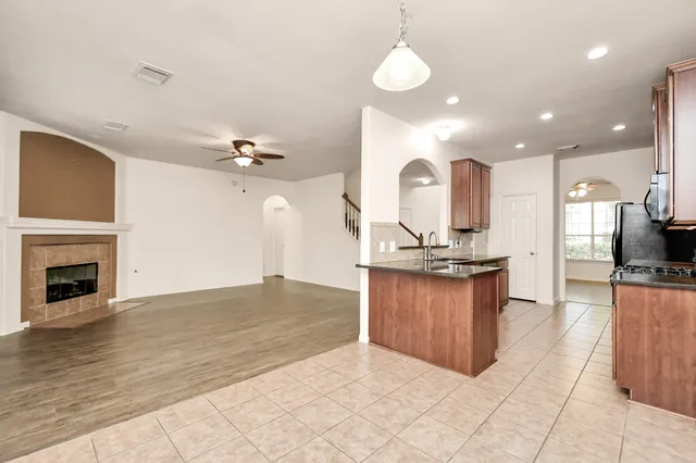 a view of a kitchen with a sink and a fireplace