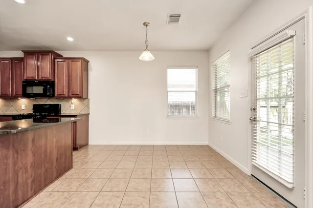 a view of a kitchen with a sink and dishwasher cabinets