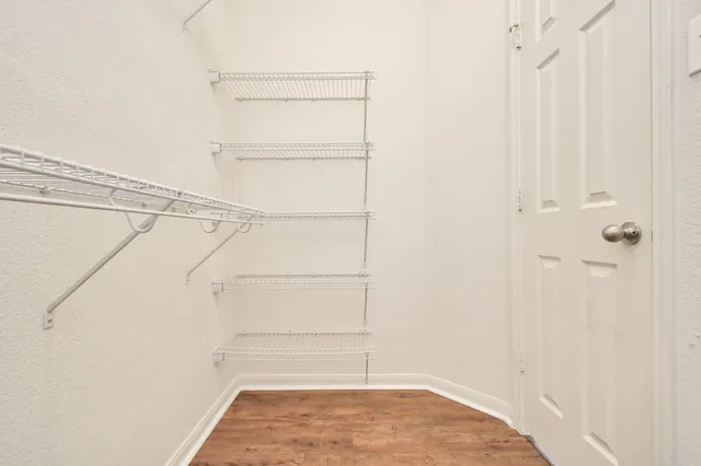 a view of walk in closet with empty racks