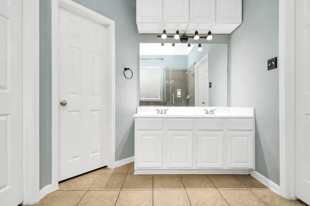 a bathroom with a sink vanity and a mirror