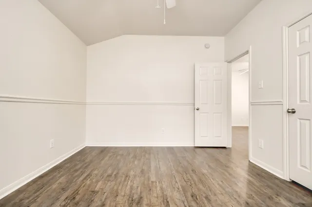 an empty room with wooden floor