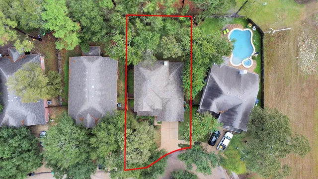 an aerial view of a house with a yard and a fountain